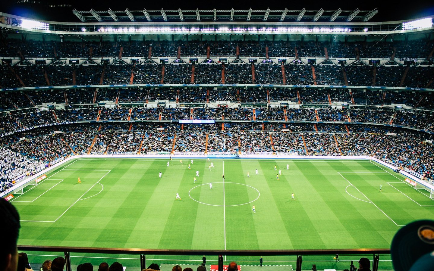 Football players on the pitch in a full stadium